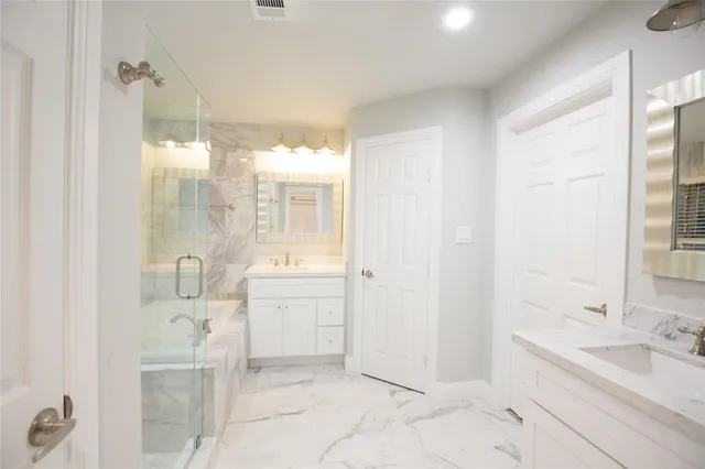 a bathroom with a granite countertop sink a toilet and shower