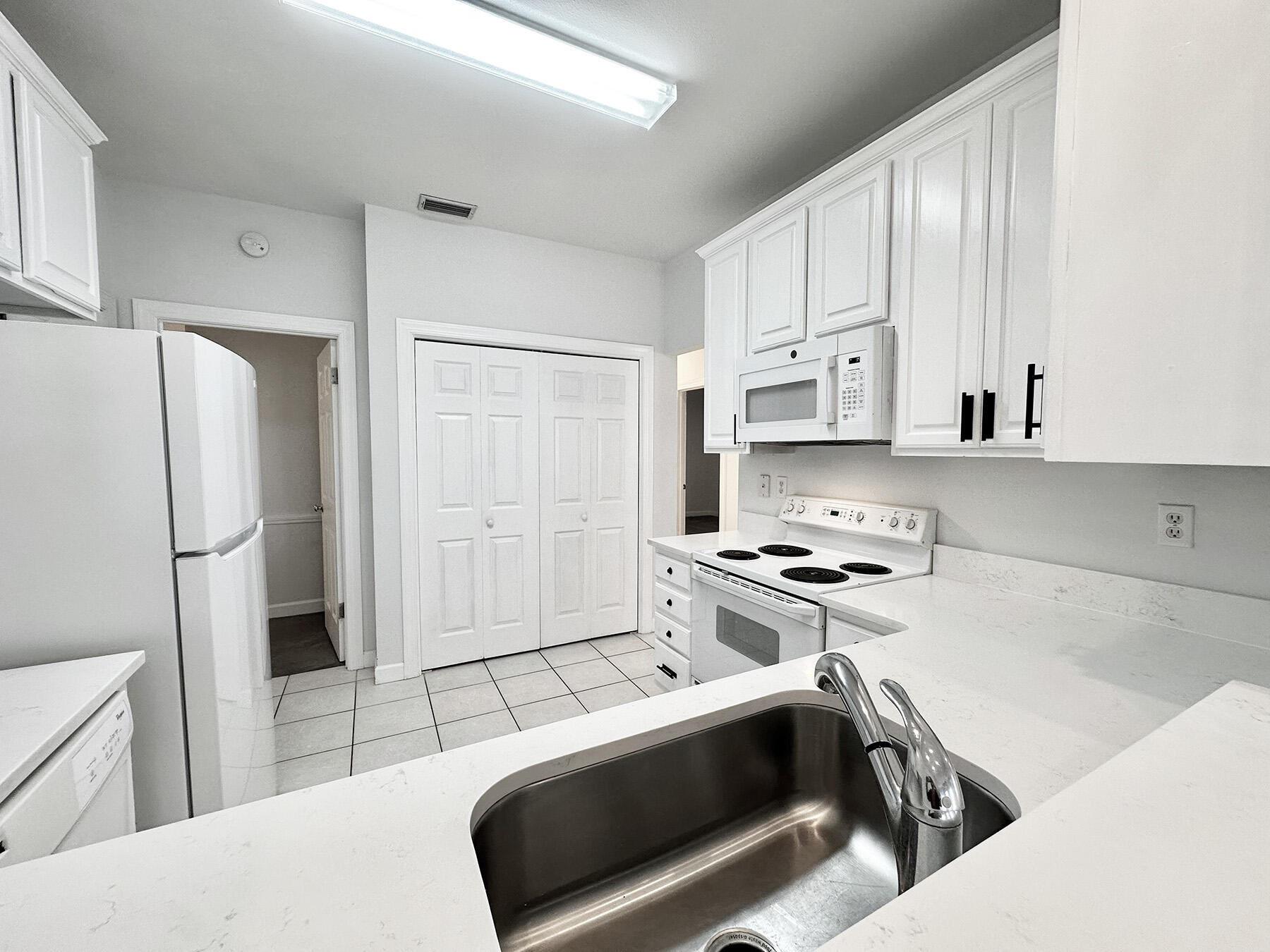 108 Mantero Way Destin, FL 32541 - Photo 12 of 36 a kitchen with stainless steel appliances a stove a refrigerator and cabinets