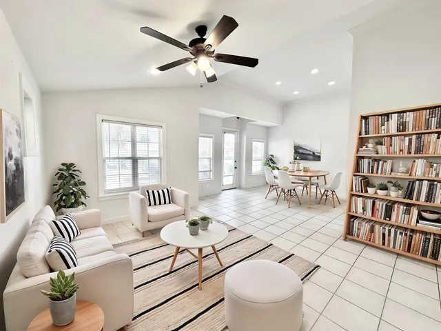 a living room with furniture and a book shelf