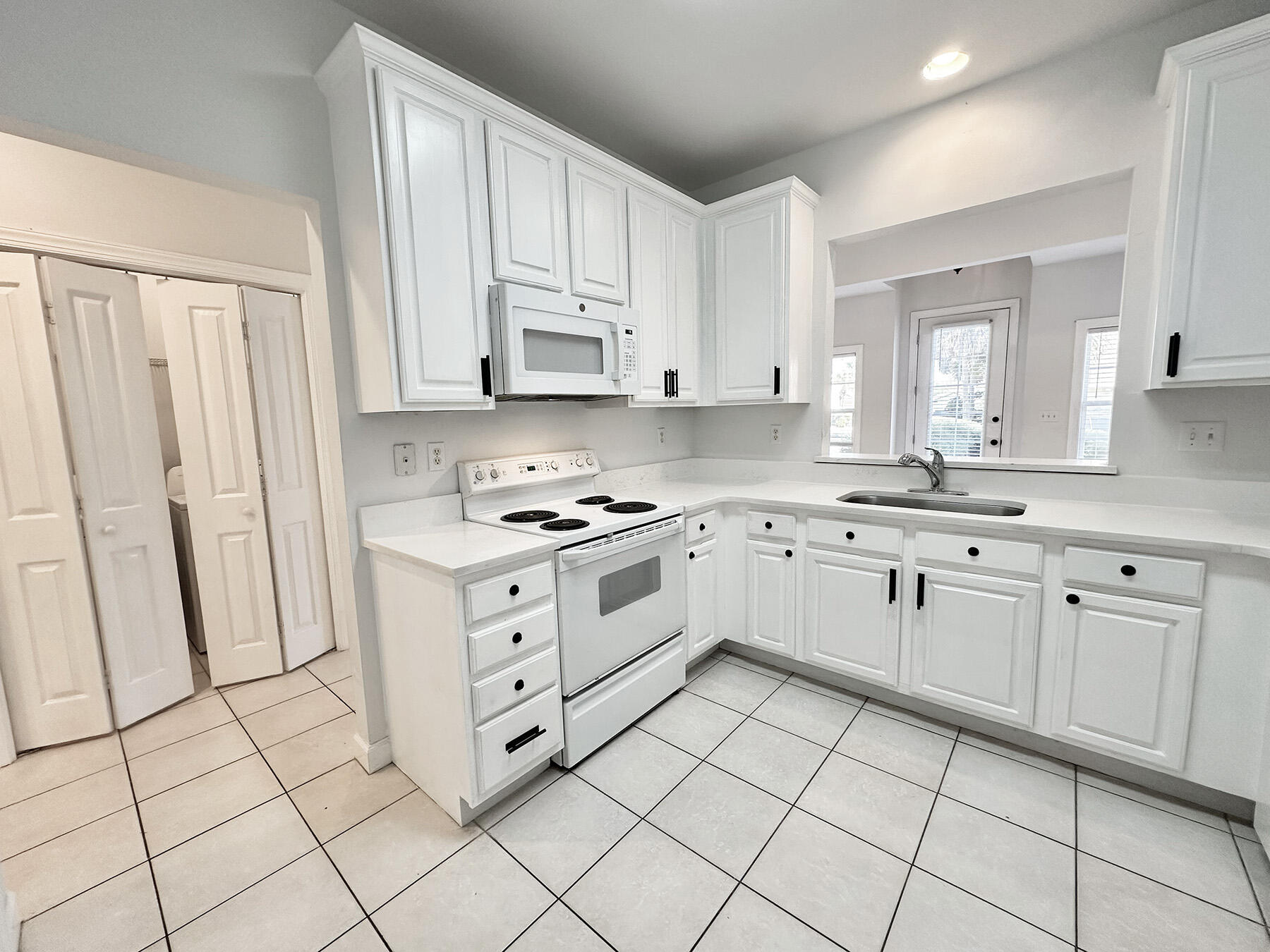 108 Mantero Way Destin, FL 32541 - Photo 18 of 36 a kitchen with white cabinets appliances and a window