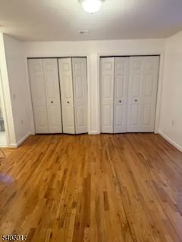 a view of room with wooden floor