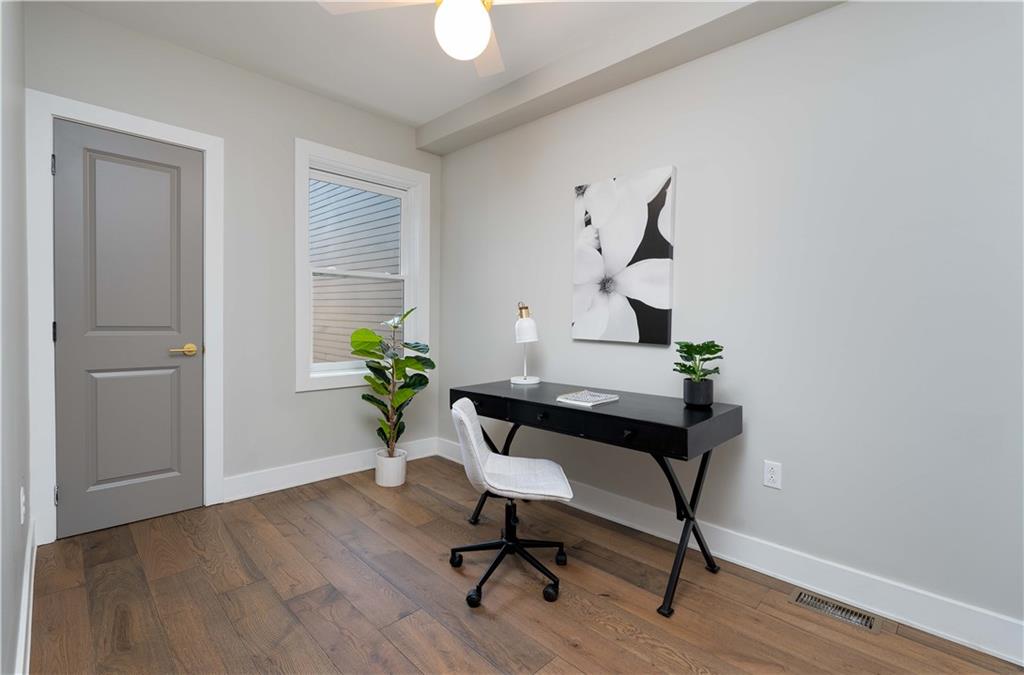 712 Cedar Avenue Pittsburgh, PA 15212 - Photo 14 of 25 a workspace with furniture and wooden floor