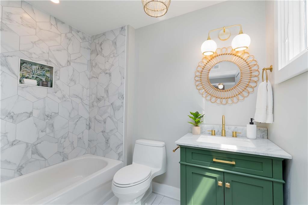 712 Cedar Avenue Pittsburgh, PA 15212 - Photo 16 of 25 a bathroom with a sink a toilet and a mirror