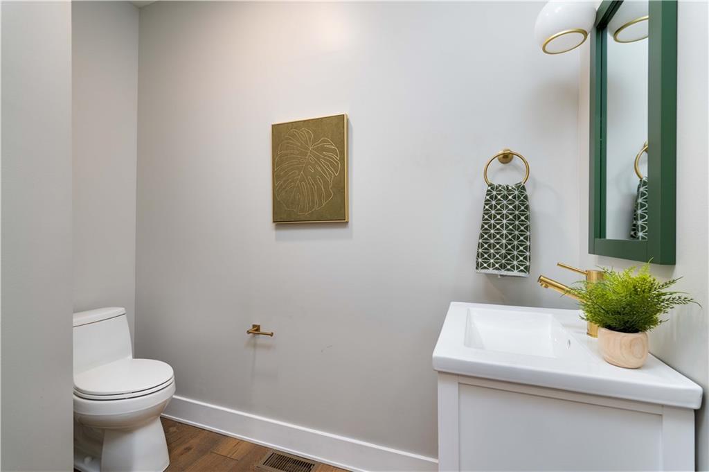 712 Cedar Avenue Pittsburgh, PA 15212 - Photo 5 of 25 a bathroom with a toilet sink and mirror