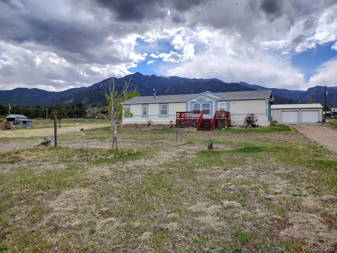 10421 West Lane Rye, CO 81069 - Photo 1 of 34 a view of a house with a yard fire pit and a large tree