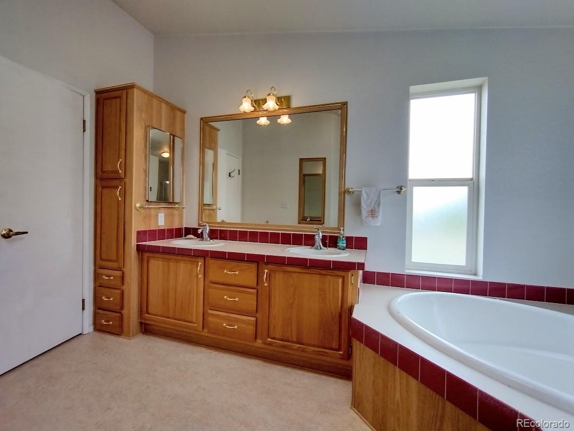 10421 West Lane Rye, CO 81069 - Photo 13 of 34 a spacious bathroom with a bathtub sink and mirror