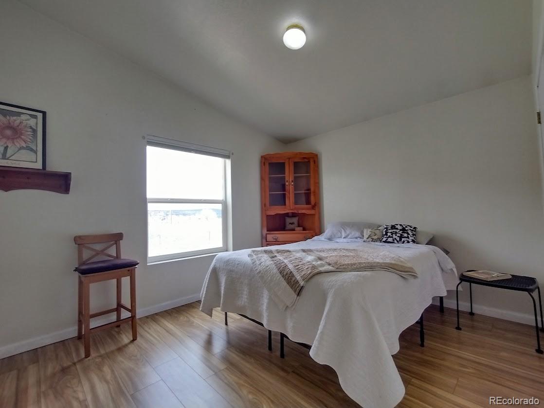 10421 West Lane Rye, CO 81069 - Photo 14 of 34 a bedroom with a bed and a window