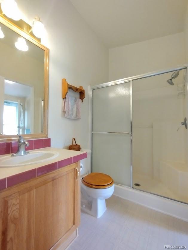 10421 West Lane Rye, CO 81069 - Photo 16 of 34 a bathroom with a sink toilet vanity and shower
