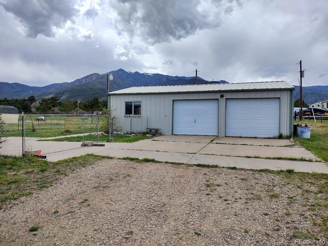 10421 West Lane Rye, CO 81069 - Photo 22 of 34 a front view of a house with a yard and a garage