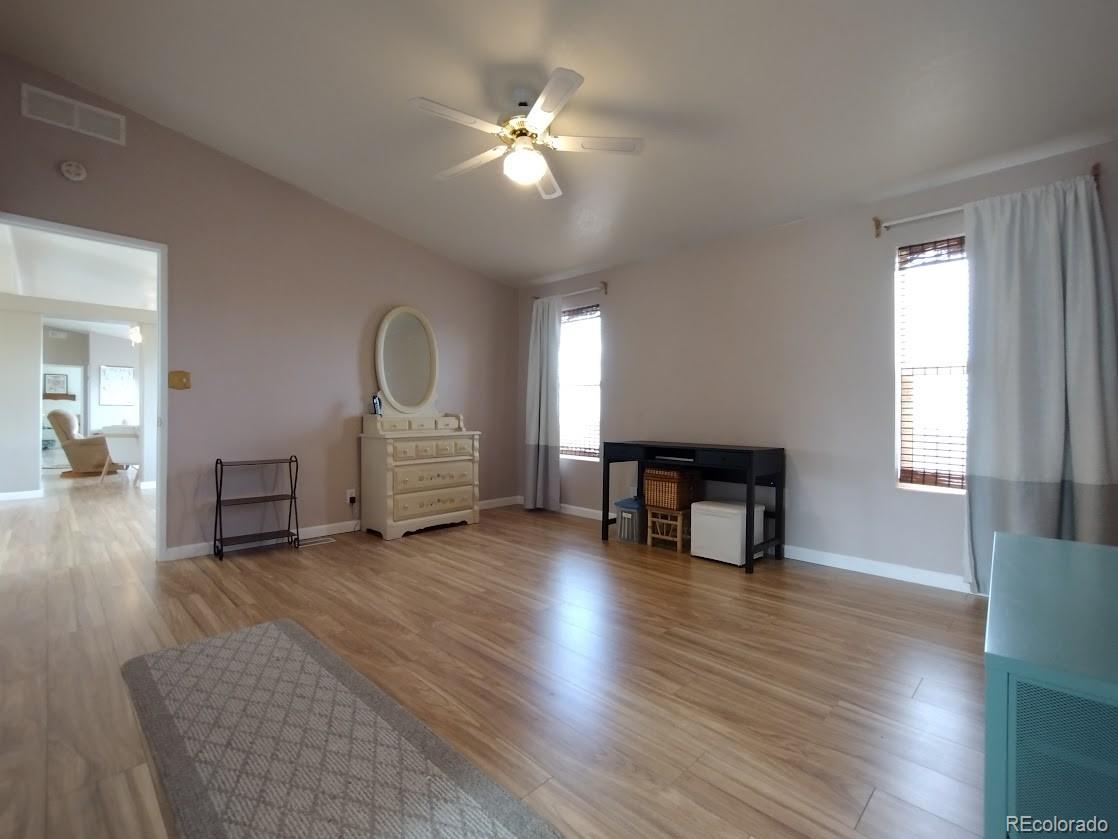 10421 West Lane Rye, CO 81069 - Photo 10 of 34 a view of a livingroom with wooden floor and a ceiling fan