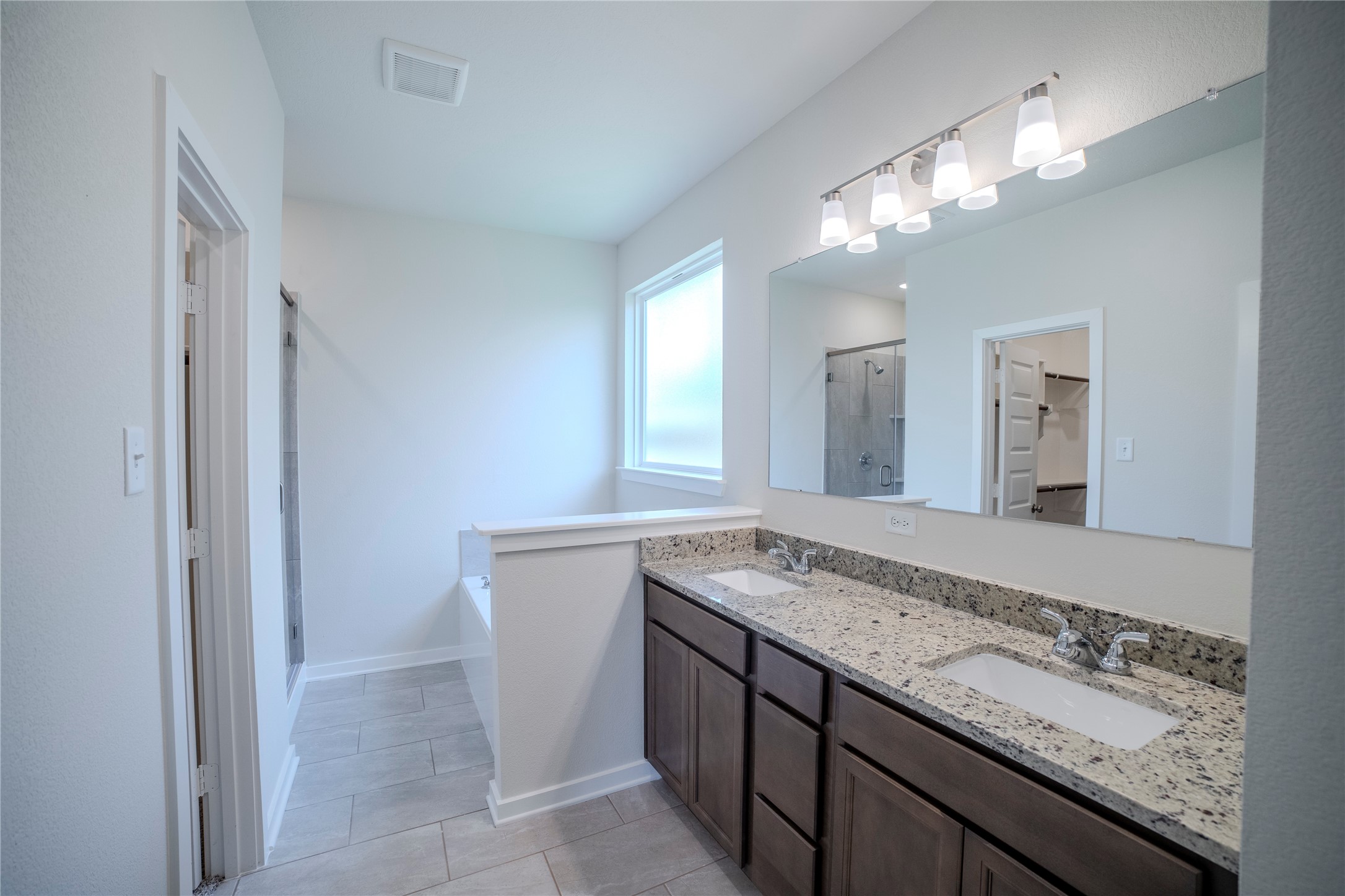 1402 Lk Rdg Drive Brenham, TX 77833 - Photo 26 of 35 a bathroom with a granite countertop sink a large mirror and a shower