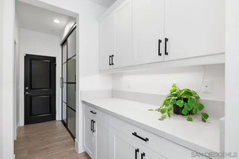 a kitchen with stainless steel appliances and white cabinets