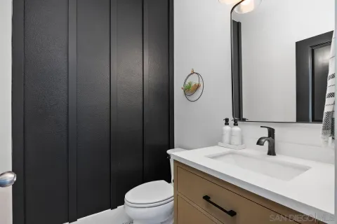 a bathroom with a sink a toilet and mirror