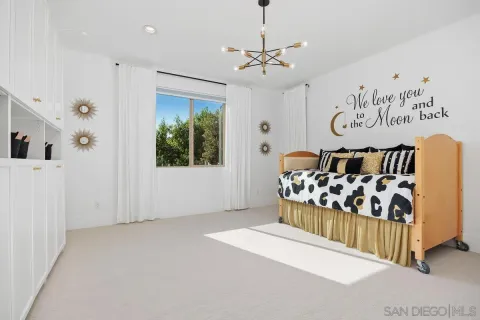a bedroom with a bed and a chandelier