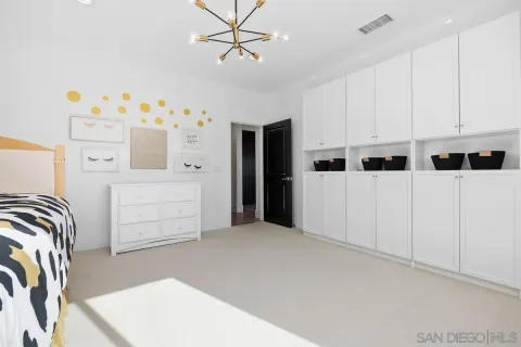 a kitchen with stainless steel appliances a refrigerator and white cabinets