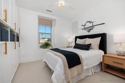 a bedroom with a bed and a window