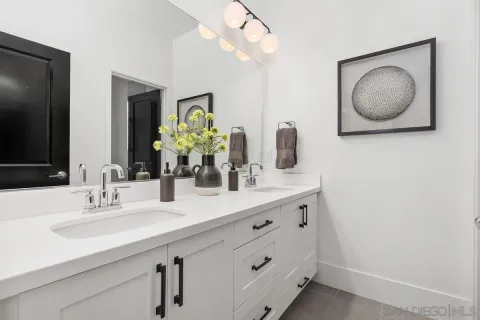 a bathroom with a double vanity sink and a mirror