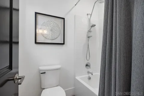 a bathroom with a toilet a sink and shower