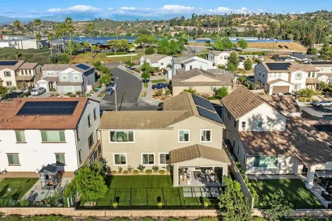 an aerial view of residential houses with outdoor space