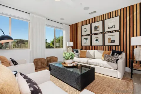 a living room with furniture and book shelf
