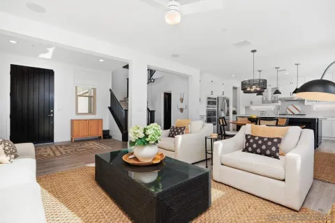 a living room with furniture and a chandelier