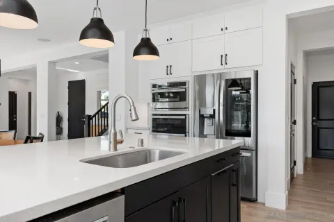 a kitchen with refrigerator a sink and a stove