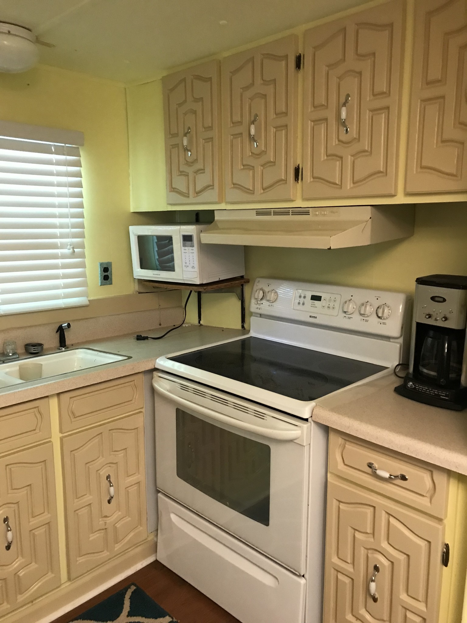 9026 Greenbriar Road Waverly, TN 37185 - Photo 14 of 19 a kitchen with white cabinets and white appliances