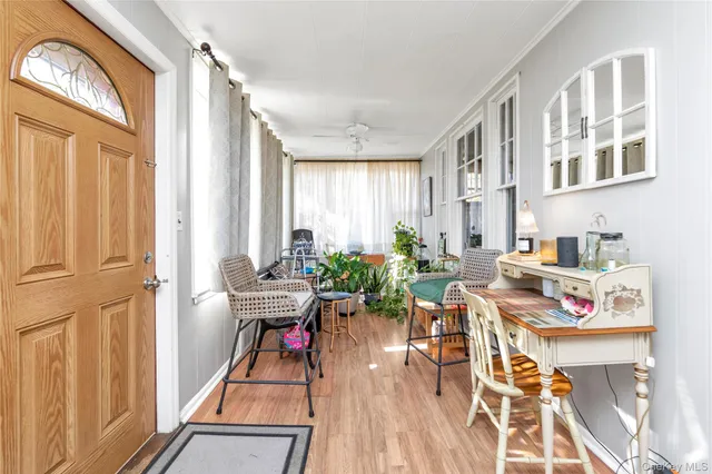 a living room with furniture a wooden floor and a window
