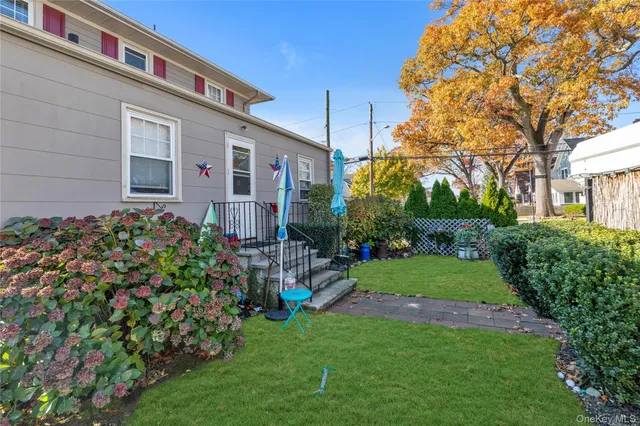 a front view of a house with a yard and fountain