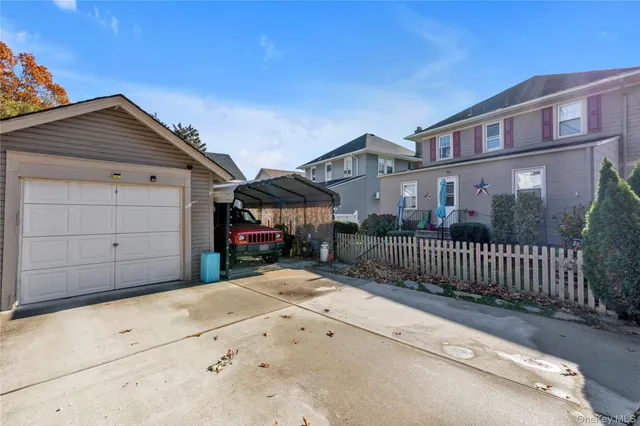 a view of a house with a wooden fence