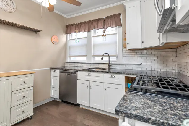 a kitchen with white cabinets and appliances