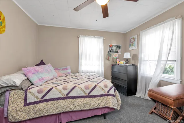 a bedroom with a bed couch and window