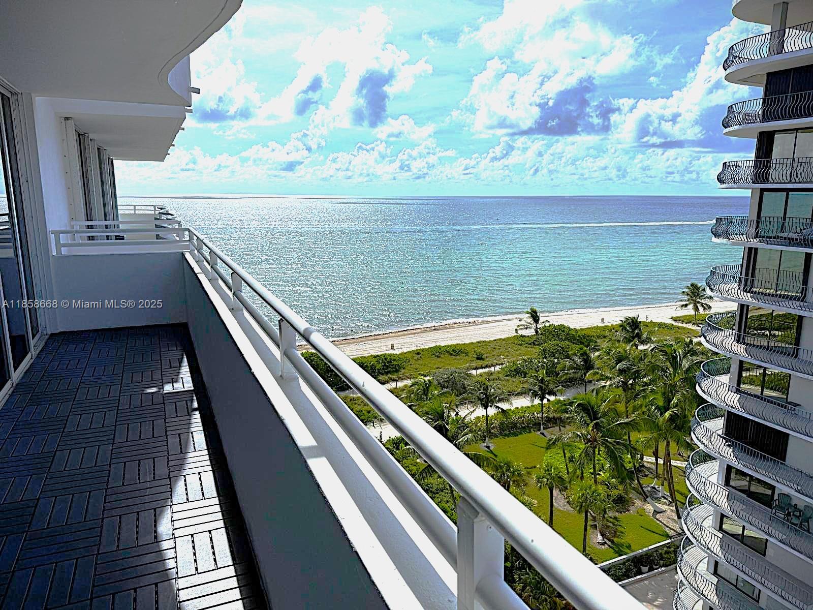 8911 Collins Avenue, Unit 1004 Surfside, FL 33154 - Photo 13 of 33 a view of a balcony with wooden floor and outdoor seating