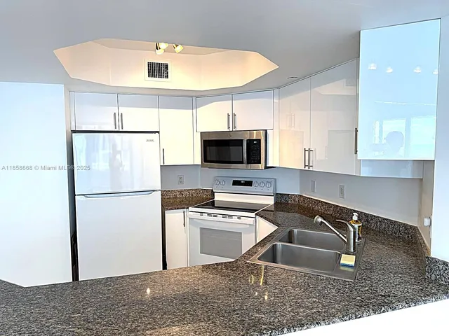 a kitchen with a sink a refrigerator and a sink