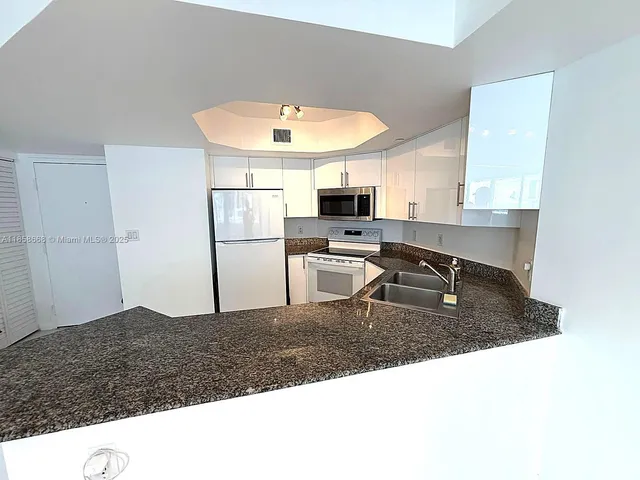 a kitchen with a sink stove and refrigerator