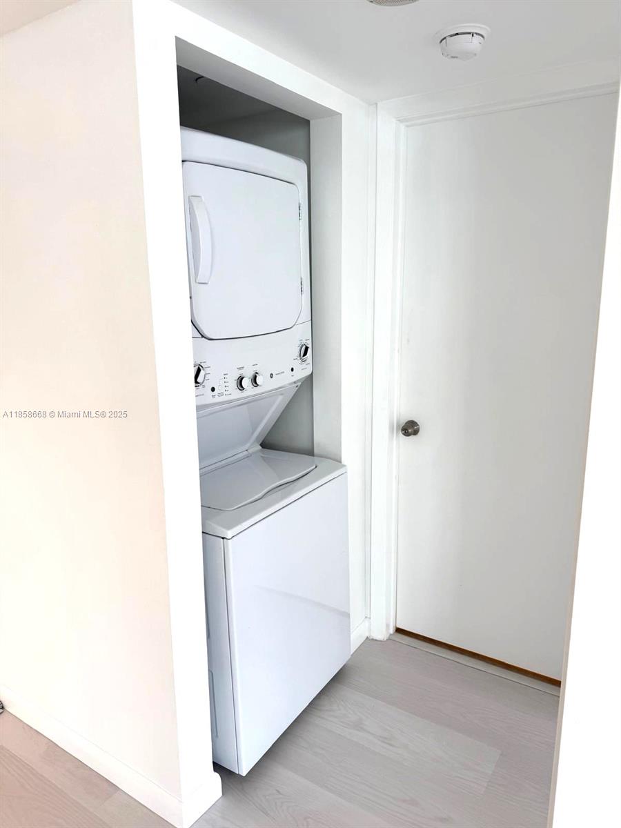 8911 Collins Avenue, Unit 1004 Surfside, FL 33154 - Photo 21 of 33 a utility room with dryer and washer