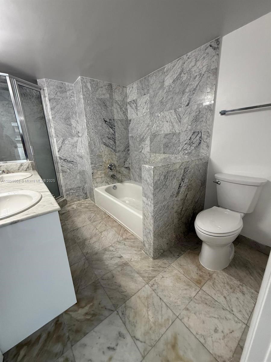 8911 Collins Avenue, Unit 1004 Surfside, FL 33154 - Photo 28 of 33 a bathroom with a toilet and a shower