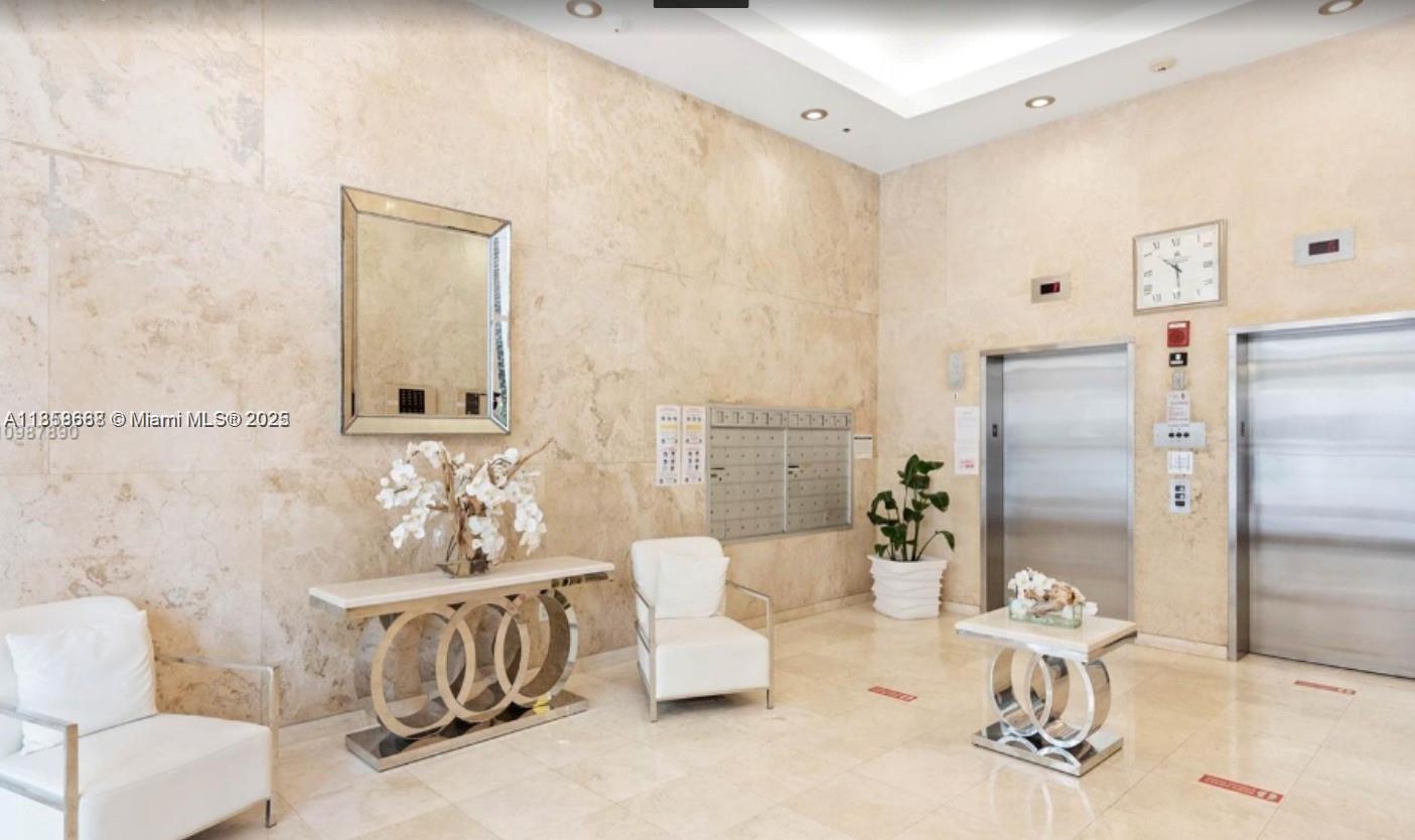 8911 Collins Avenue, Unit 1004 Surfside, FL 33154 - Photo 31 of 33 a living room with furniture and white walls