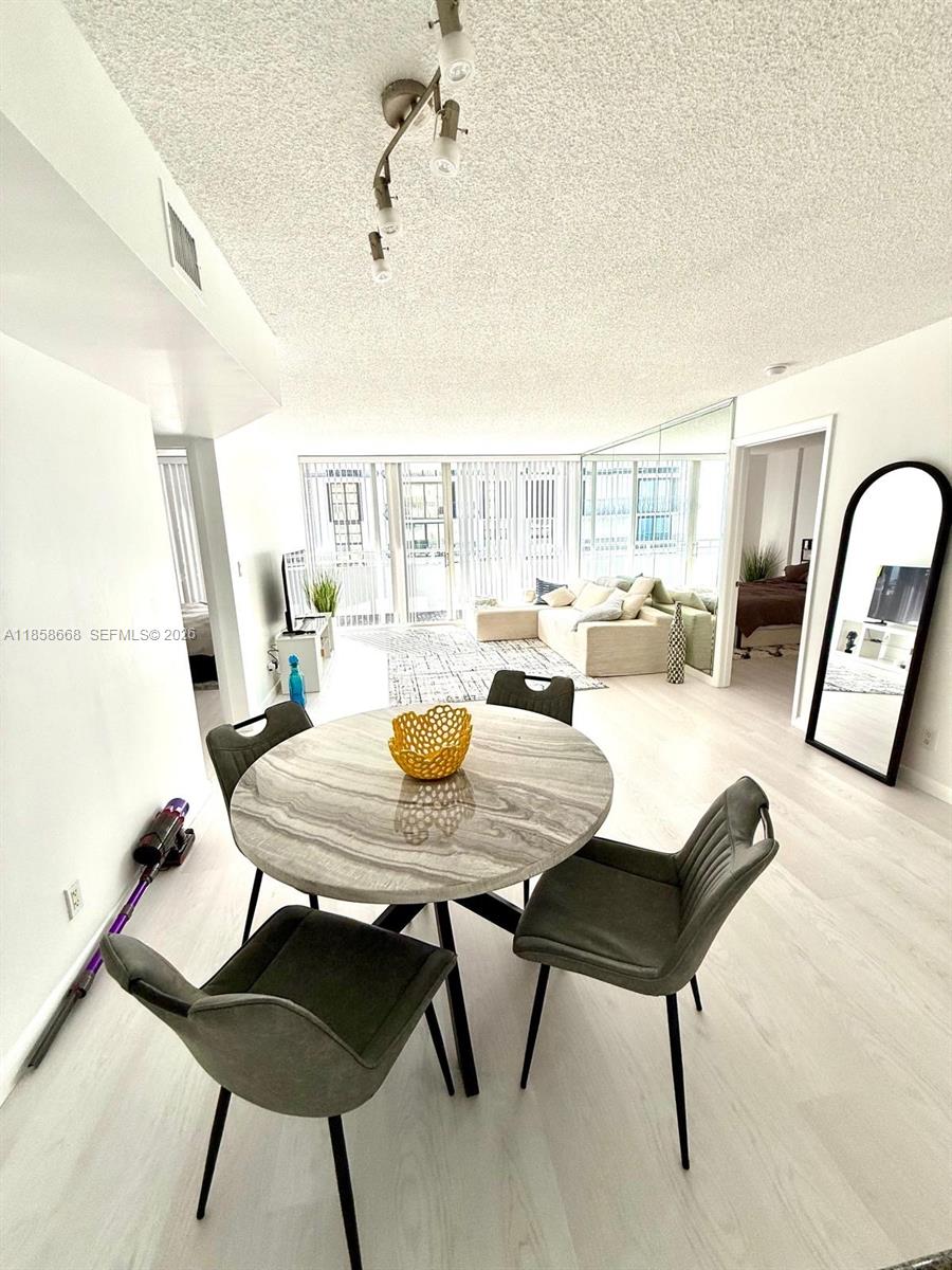 8911 Collins Avenue, Unit 1004 Surfside, FL 33154 - Photo 36 of 38 a view of a dining room with furniture