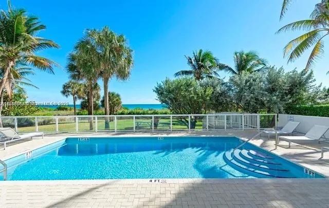 a view of a swimming pool with a lounge chair