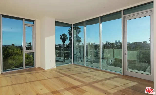 a view of an empty room with glass door