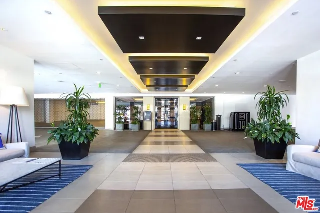 a lobby with furniture and potted plant