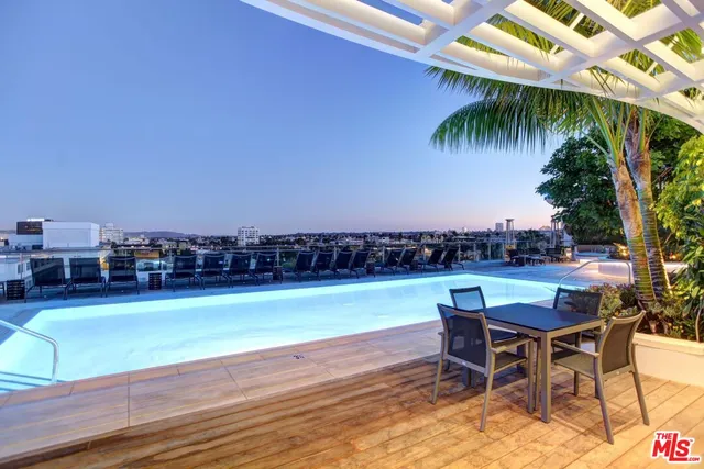 a view of a swimming pool and lounge chair