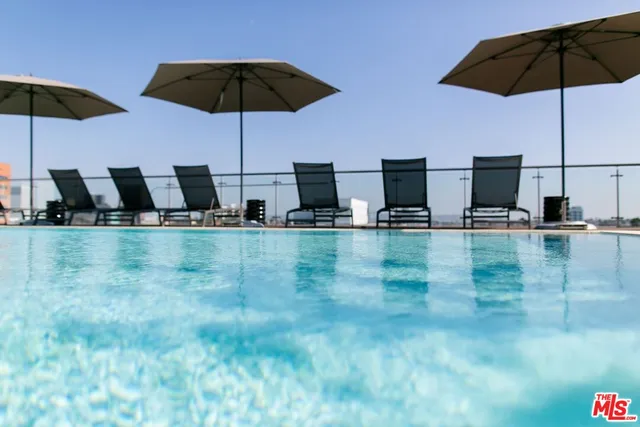 a kitchen with stainless steel appliances a sink a table and chairs