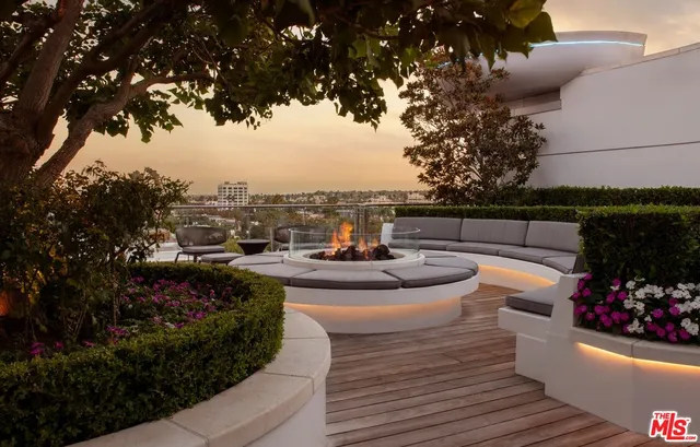a view of a patio with couches and potted plants