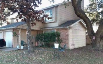 a view of a house with a tree