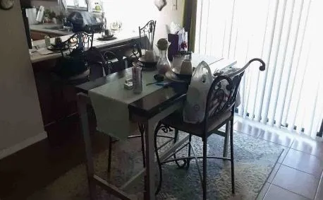 a view of a dining room with furniture and window