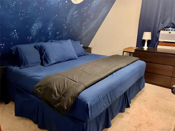 a bedroom with a large bed and a large window