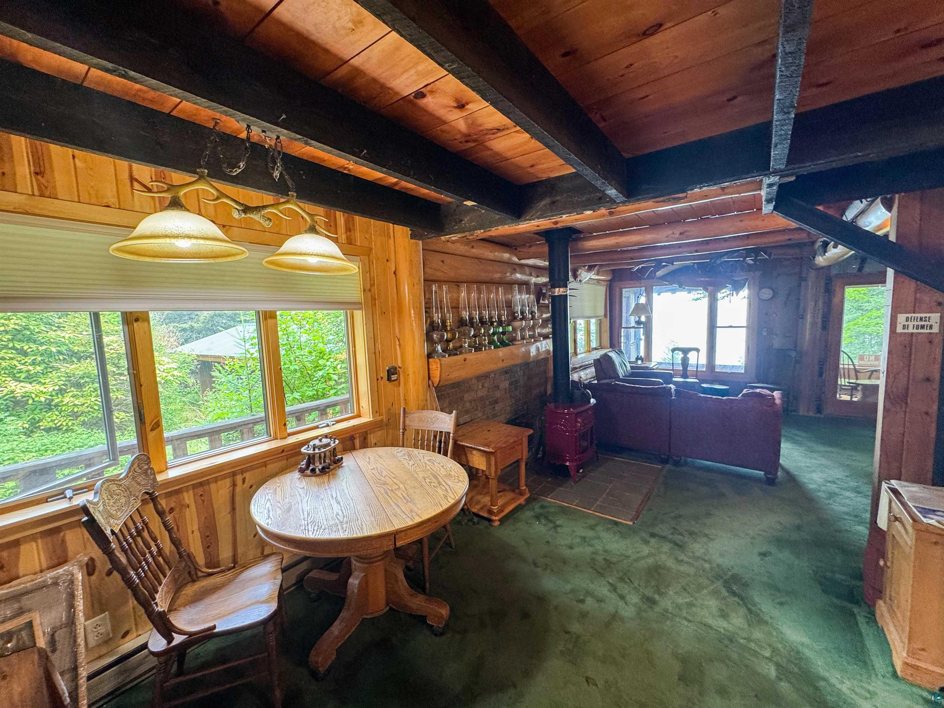 465 South Gunflint Lake Road Grand Marais, MN 55604 - Photo 21 of 46 Exposed wood beam ceiling with wood-finish flooring