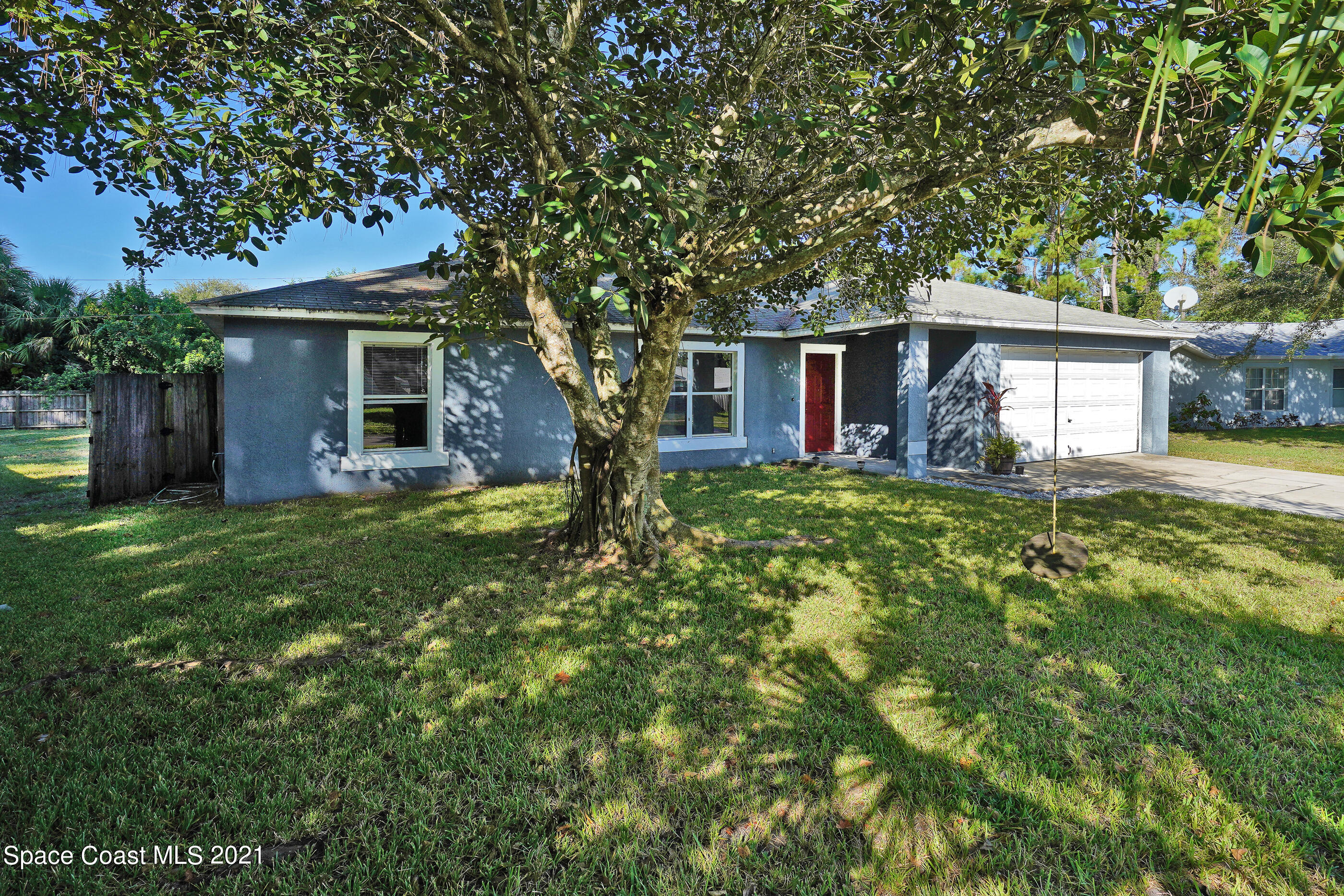 905 Macco Road Cocoa, FL 32927 - Photo 2 of 27 a front view of house with yard and green space